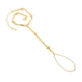 A gold handchain featuring geometric triangle zircon and cubic zirconia bar elements.