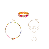Three jewelry pieces arranged on a plain white background: a beaded choker necklace with multicolor beads and a small gold charm, a gold flower bracelet with pink and orange stones, and a delicate gold chain necklace with a geometric pendant and hanging ring.