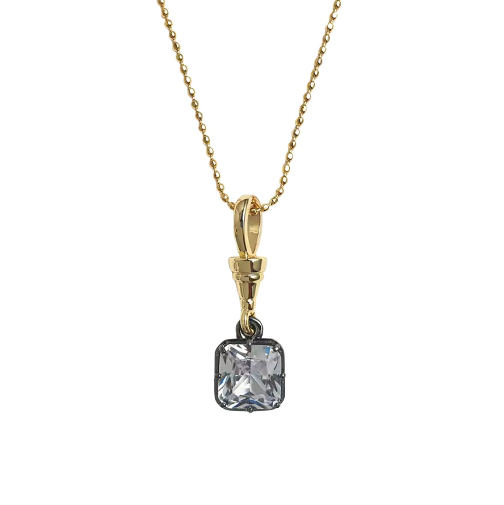 A gold chain necklace with a square cushion-cut clear gemstone pendant set in a dark metal bezel, shown against a plain white background.